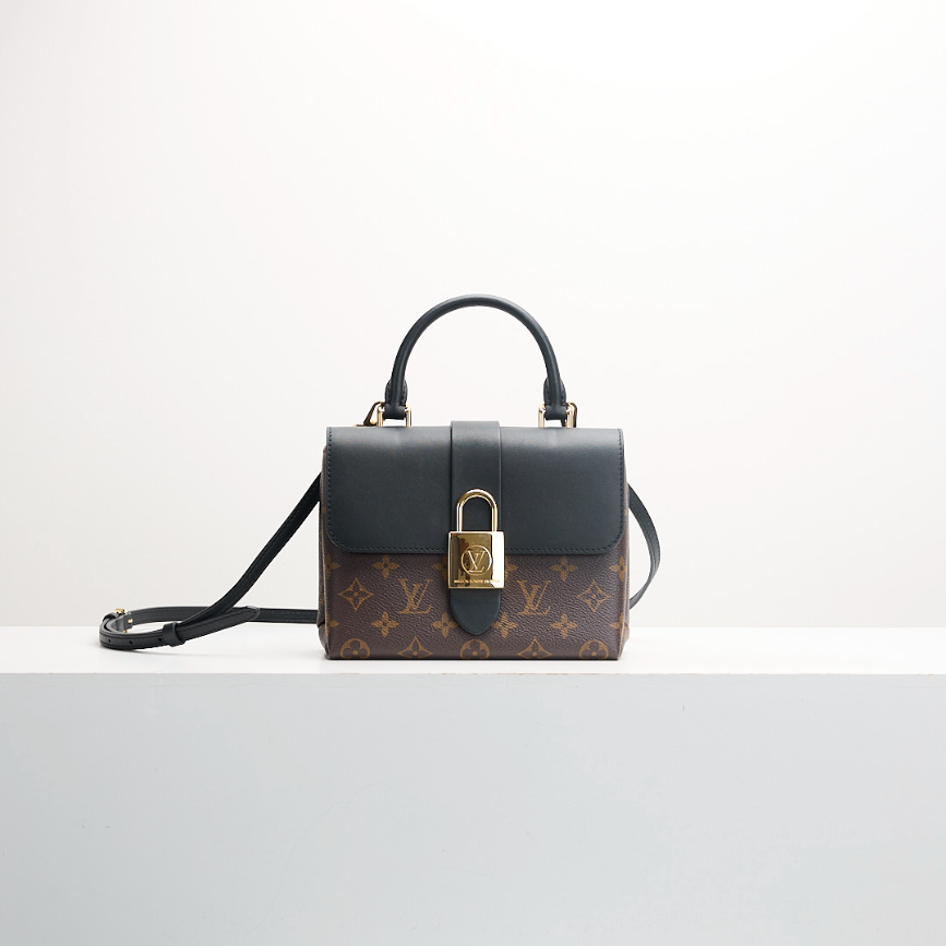 Women holding monogram WOC bag with old money style outfit