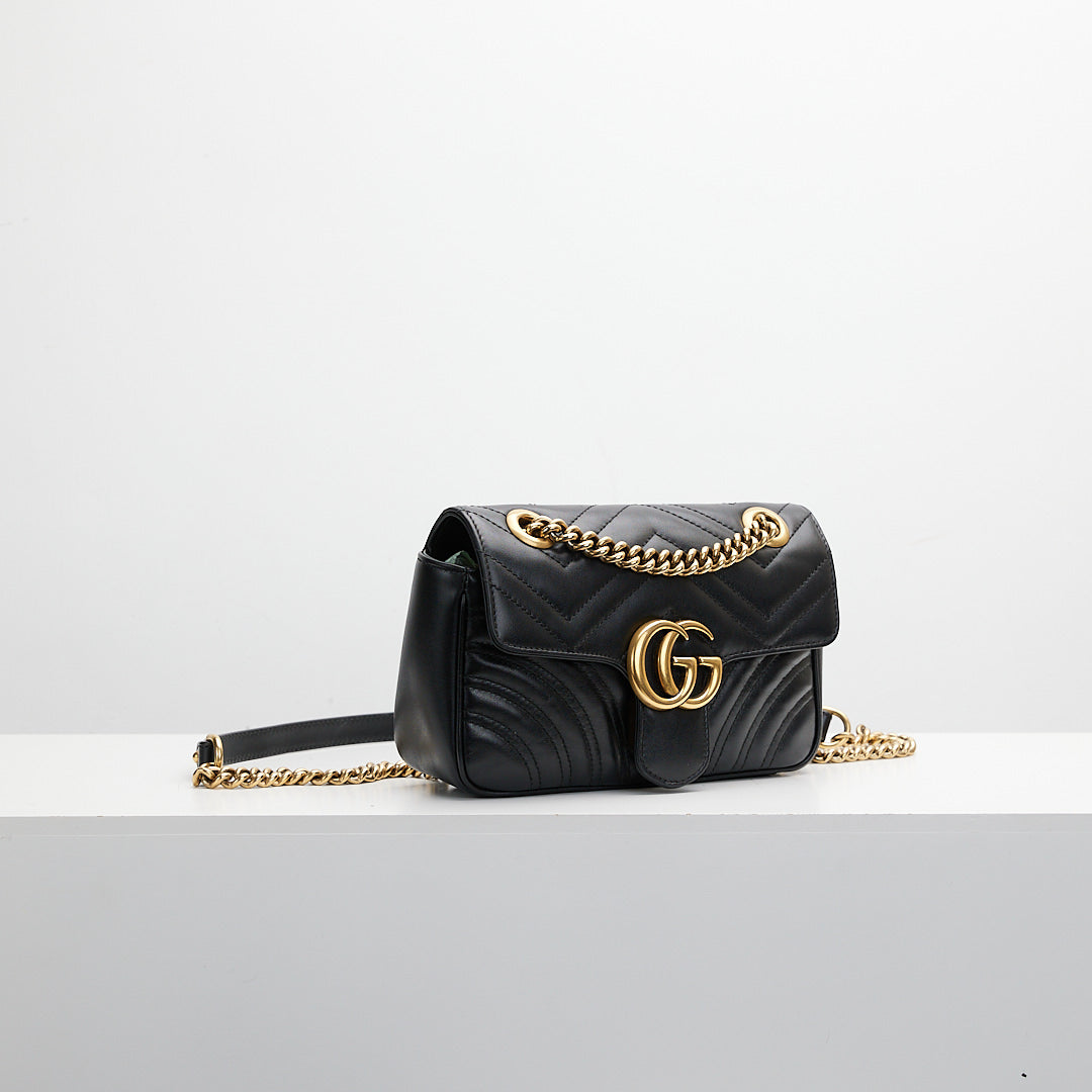 Black bag with gold tone strap