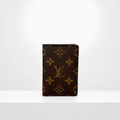 Brown small wallet standing upright on a white surface against a white background.