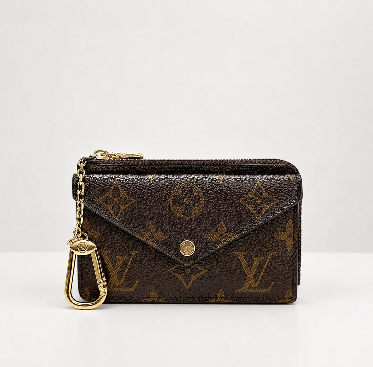 zip-around wallet with an envelope-style flap closure and a gold-tone chain key ring, photographed on a clean white background.