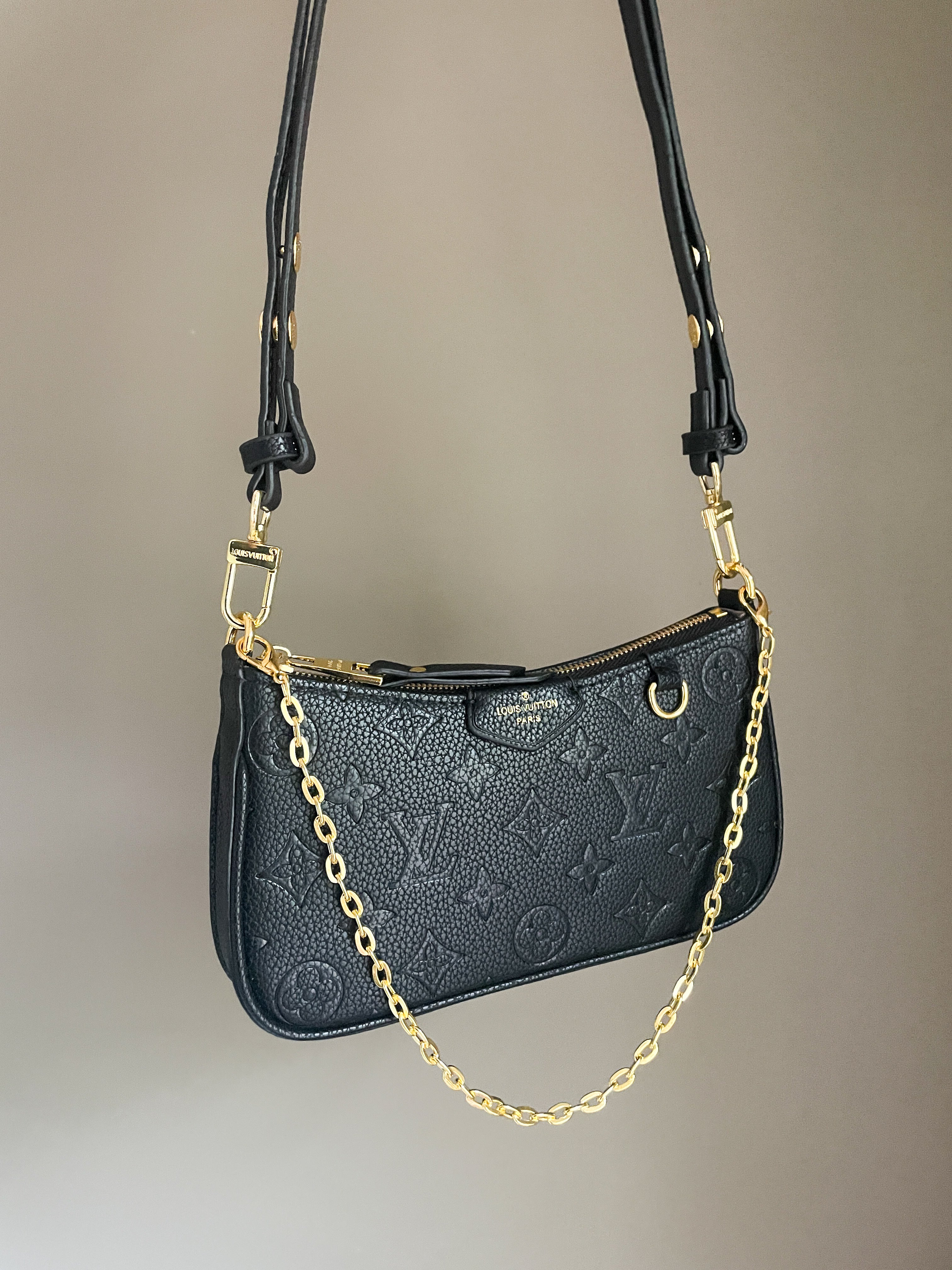 Black structured shoulder bag with durable grained texture and gold chain strap, versatile 3-way pouch