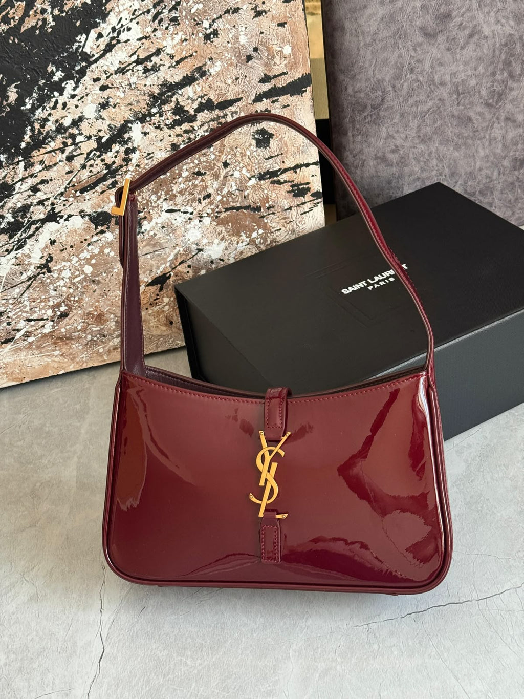 Burgundy patent leather hobo bag with gold hook closure, glossy 90s style shoulder bag