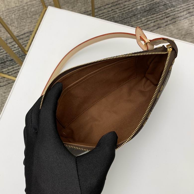 Close up of durable coated canvas in brown check pattern with gold zipper detail.