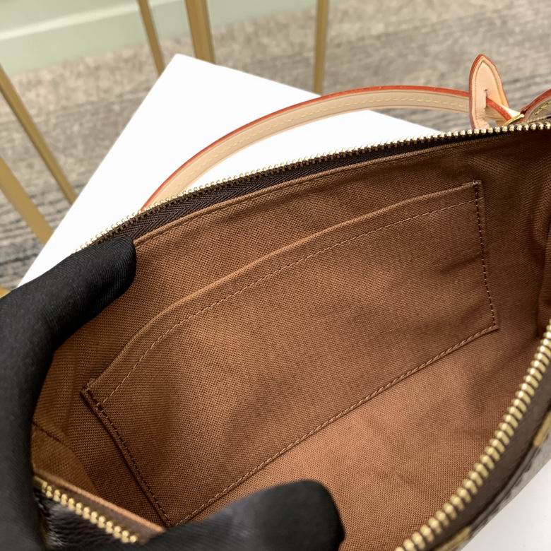 Close up of durable coated canvas in brown check pattern with gold zipper detail