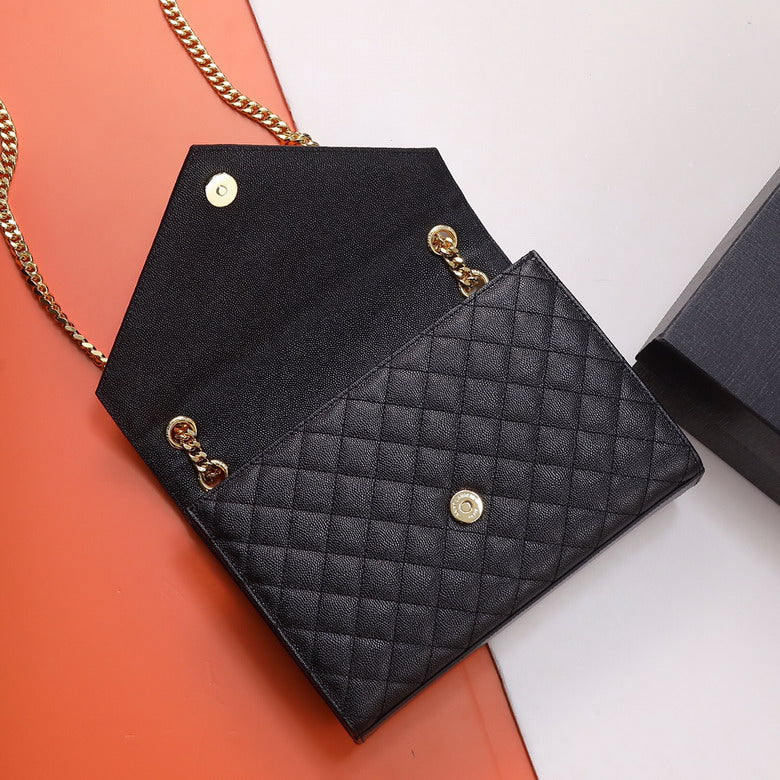 Close up of mix quilting pattern on black envelope bag, convertible clutch with gold chain