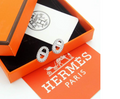 Silver stud earrings with crystal pave marine link design, luxury orange box packaging.