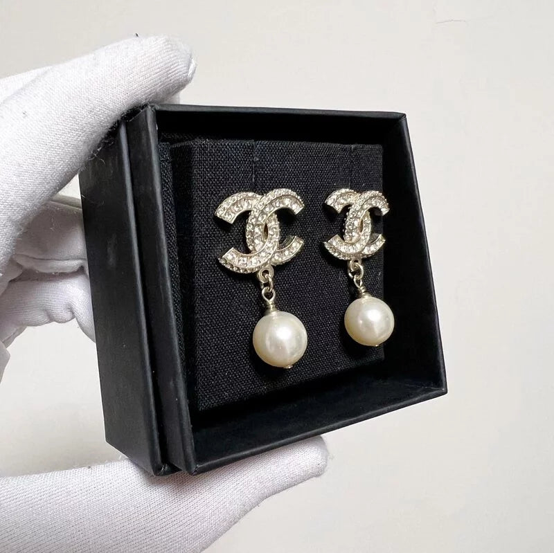 Silver pearl drop earrings with luxury jewelry box and shopping bag, sourced designer alternative.