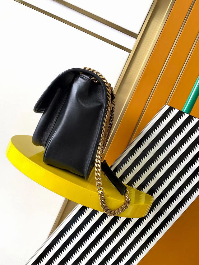 Medium black smooth leather shoulder bag with chevron quilting and antique gold chain strap. Minimalist rock chic style