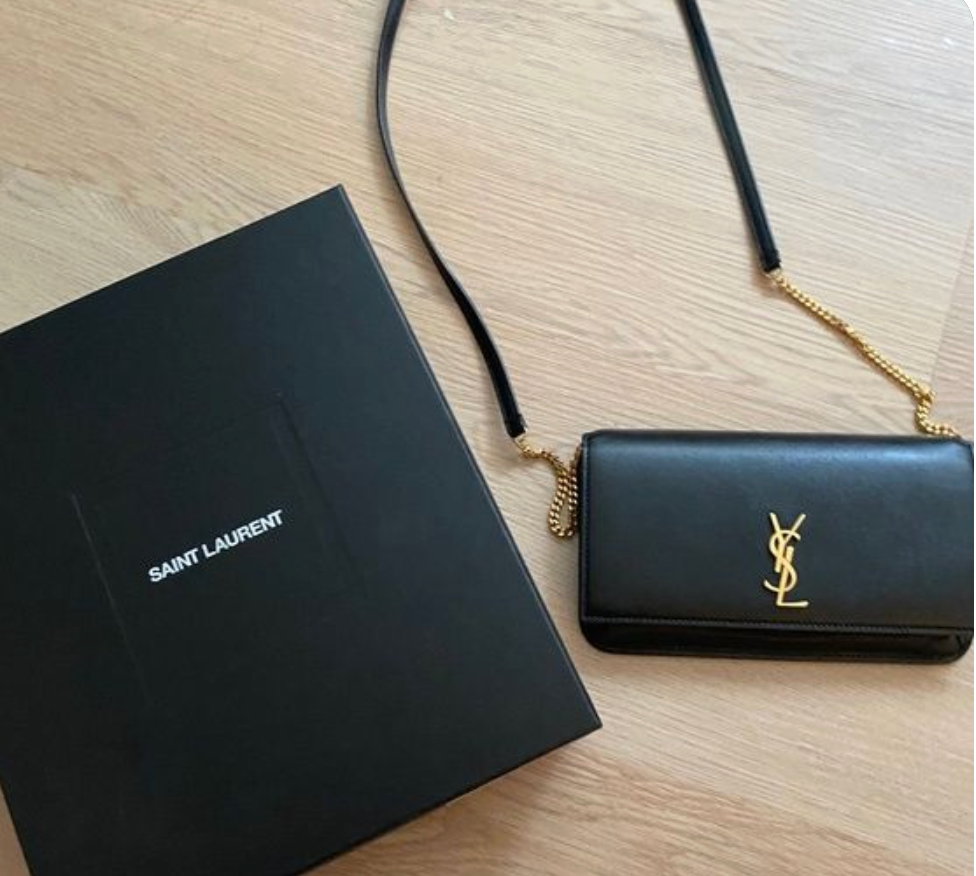 Black smooth leather phone holder with gold interlocking logo, fits iPhone Pro Max