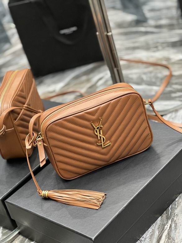 Tan vegan leather camera bag with chevron quilting and gold tassel charm, crossbody style.