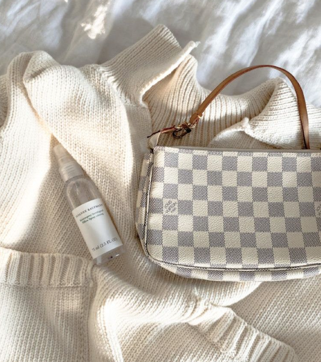 Checkered handbag and bottle on a textured surface