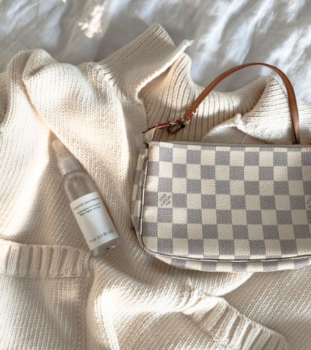 Checkered handbag and bottle on a textured surface